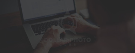 man typing on laptop with scorm player on video screen.